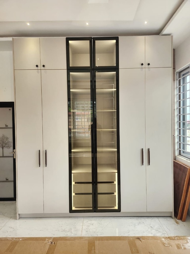 Floor-to-ceiling white wardrobe with glass display cabinets